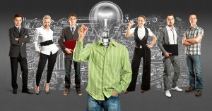 Idea concept. Lamp Head and Business team against different back